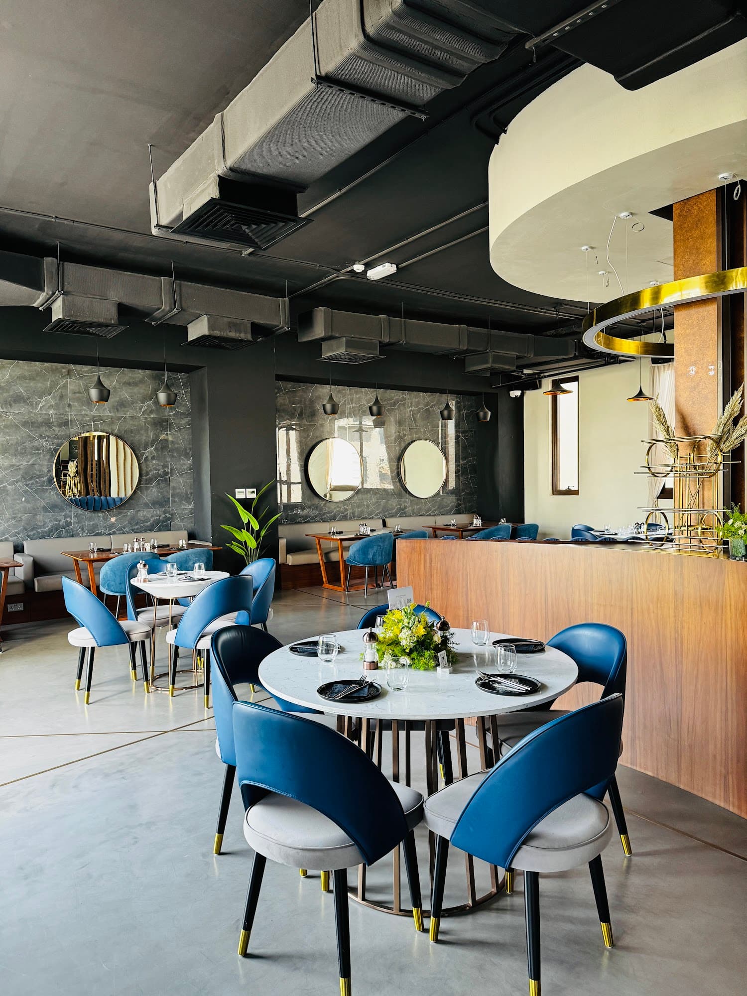 Velvet seating and brass lighting inside M1 Cafe Lounge